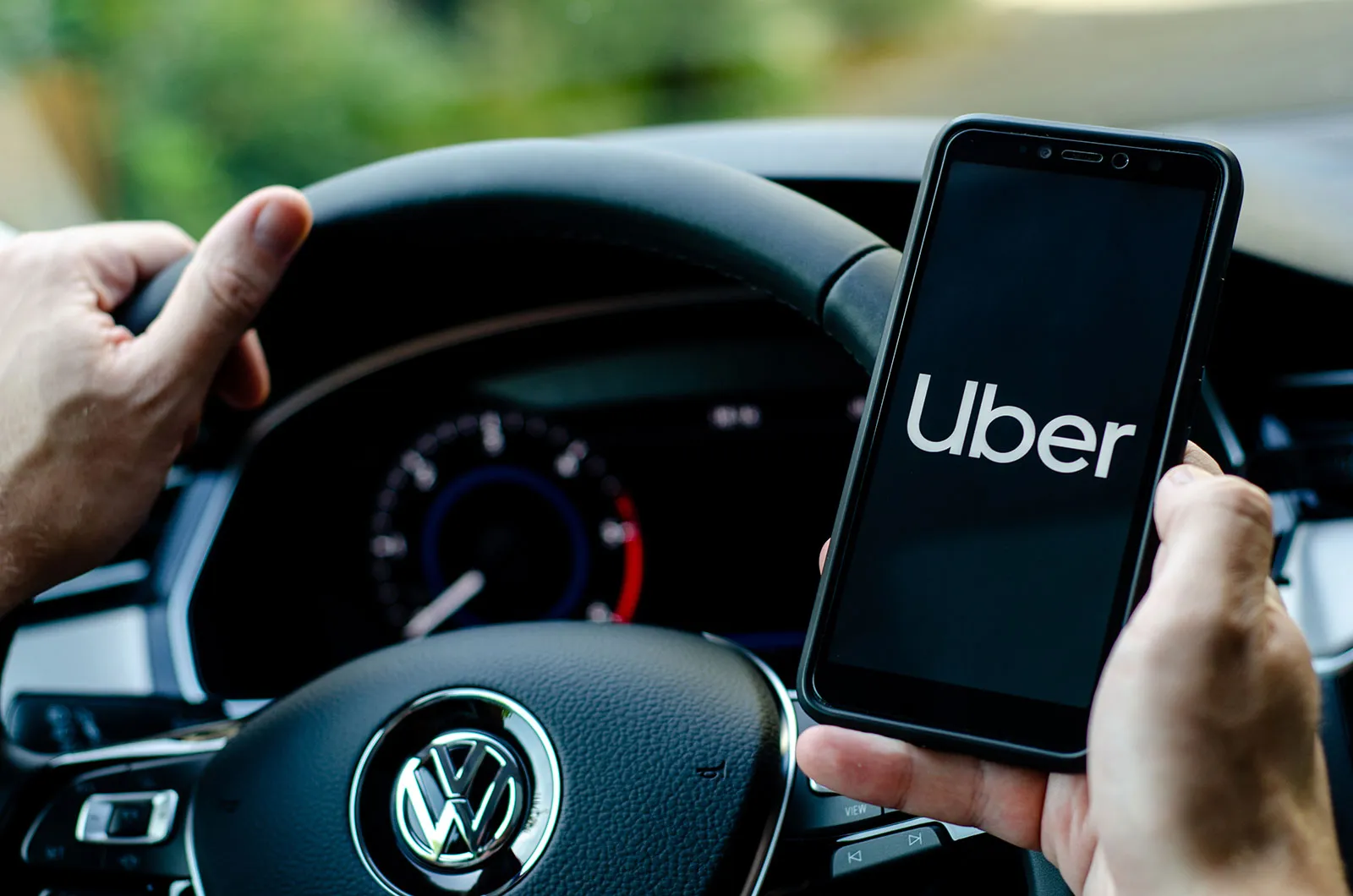 Uber fined £246m for GDPR data breach | Image 1 Uber fined £246m for GDPR data breach (uber driver holds smartphone in car.jpg)